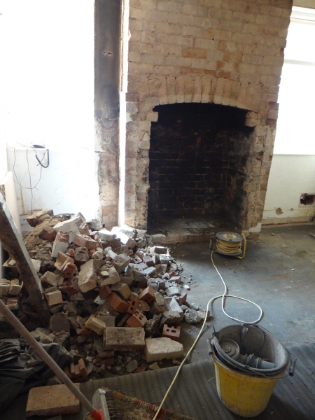 Fireplace broken out and old material removed